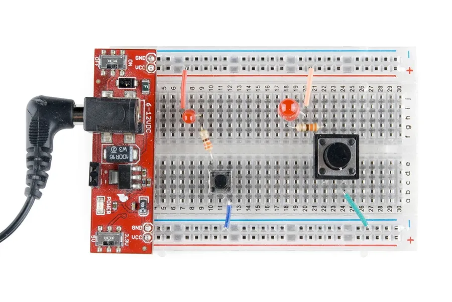 Electronic components like resistors, LEDs, and wires inserted into a breadboard.