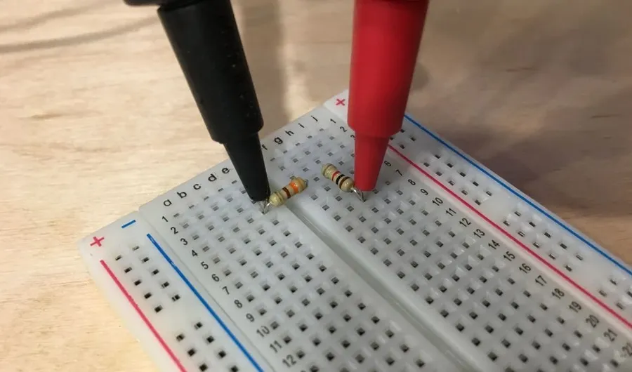 A 220k resistor inserted in a breadboard.