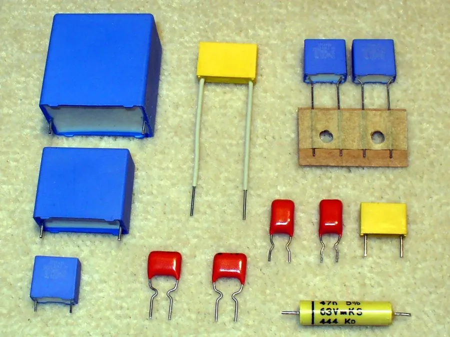 An assortment of capacitors, including ceramic, electrolytic, and tantalum types.