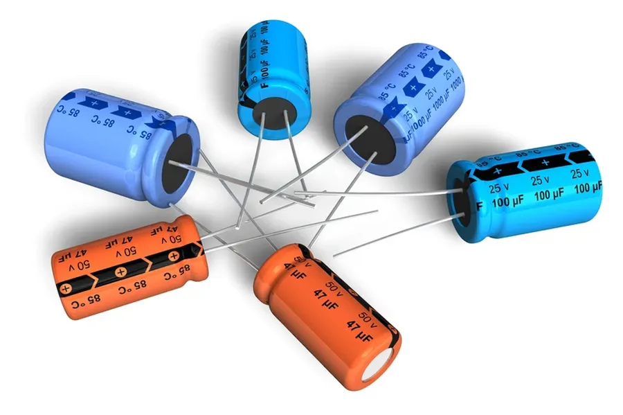 An assortment of electrolytic capacitors, some cylindrical and others radial.