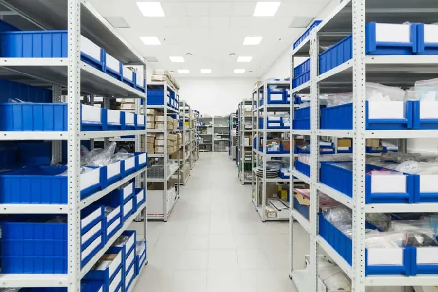 A warehouse with shelves filled with boxes containing electronic parts.