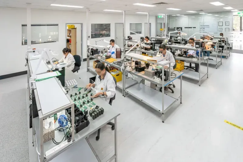 Technicians working on PCB assembly in a workshop