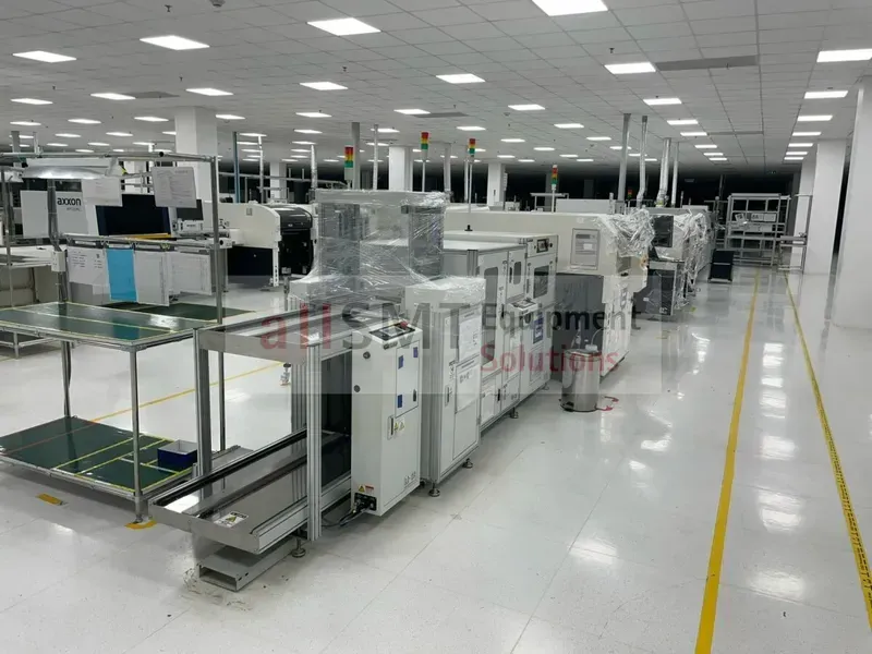 A wide shot of a PCB manufacturing factory production line with machines and workers