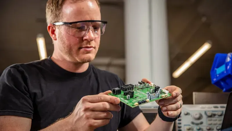 An engineer operating PCB design software on a computer